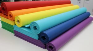 High-quality image showcasing Favourite Fab's laminated nonwoven sheets. The image depicts various applications, including medical gowns, protective packaging, and agricultural covers, highlighting the versatility and superior quality of the material. The sheets are shown in different colors and textures, demonstrating the customization options available.